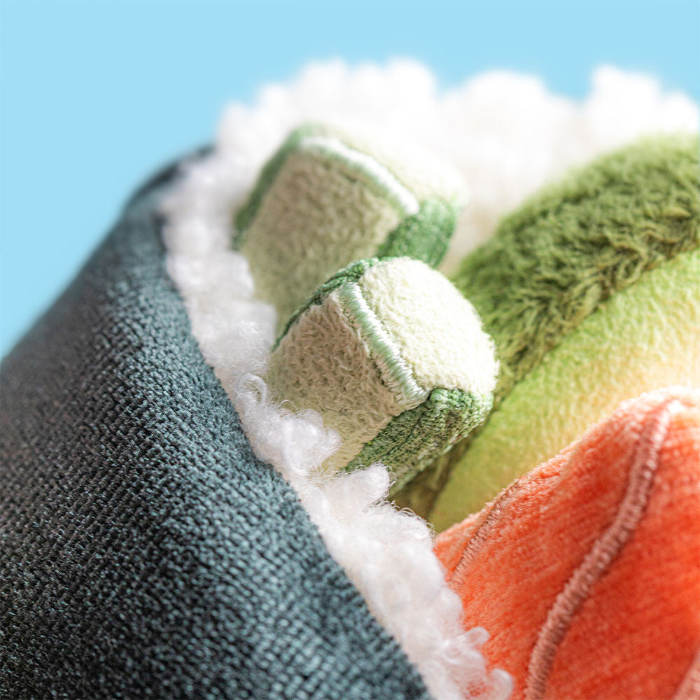 Close-up of Coneroi Temaki showing fluffy white rice, green fabric fillings and an orange salmon-style detail.