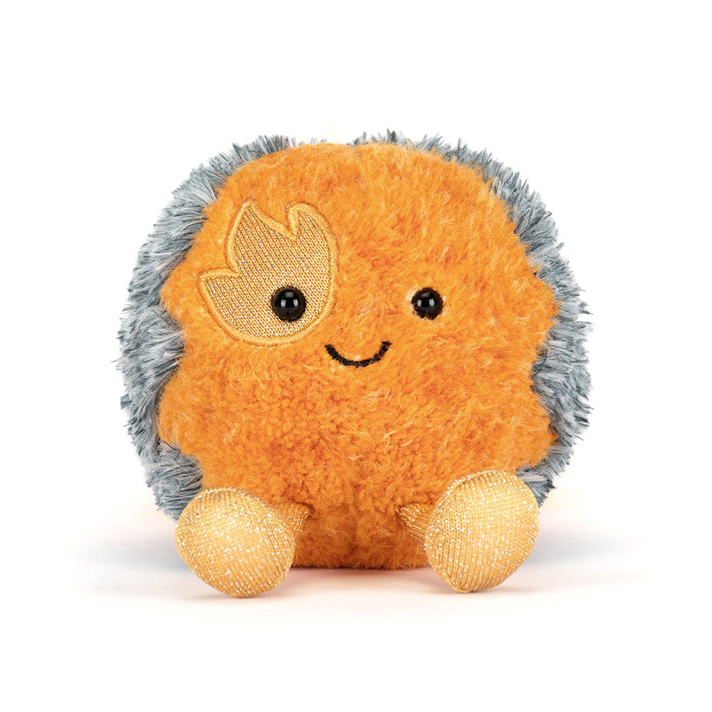 Front view of Jellycat Amuseables Space Comet with a smiling orange face, golden eye patch and matching feet.