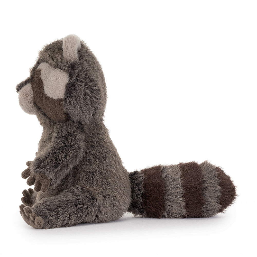 Side view of Jellycat Trixiwoo Raccoon showing its long striped tail and little paws.