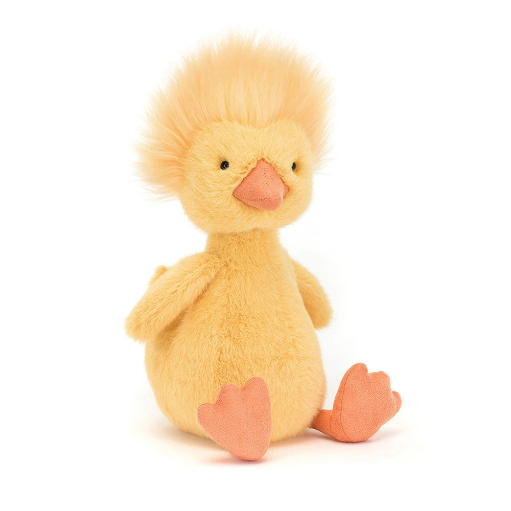 Plush yellow duck toy, with fluffy yellow hair, and orange beak and bead black eyes, sitting on a white background.