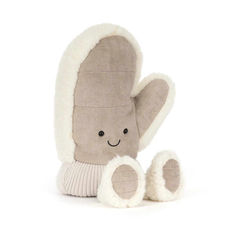 A plush winter mitten toy in a warm taupe-brown fabric with cream sherpa trim. Featuring a simple embroidered smiley face and small feet, shown on a clean white background.