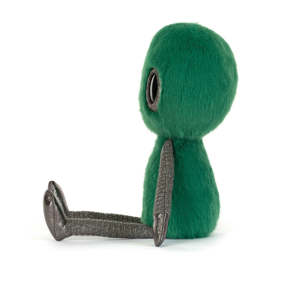 Rear view of Jellycat Zyllan Alien showing its green plush head and body with textured silver arms.