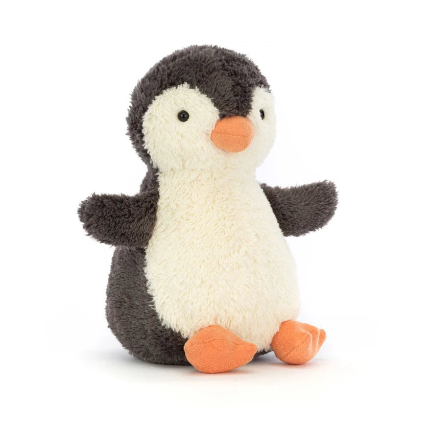A plush penguin toy with a dark gray and cream-colored body, a bright orange beak, and orange feet, photographed on a clean white background.