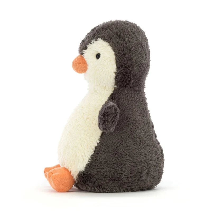 Stuffed penguin toy on a white background, with hard black bead eyes.